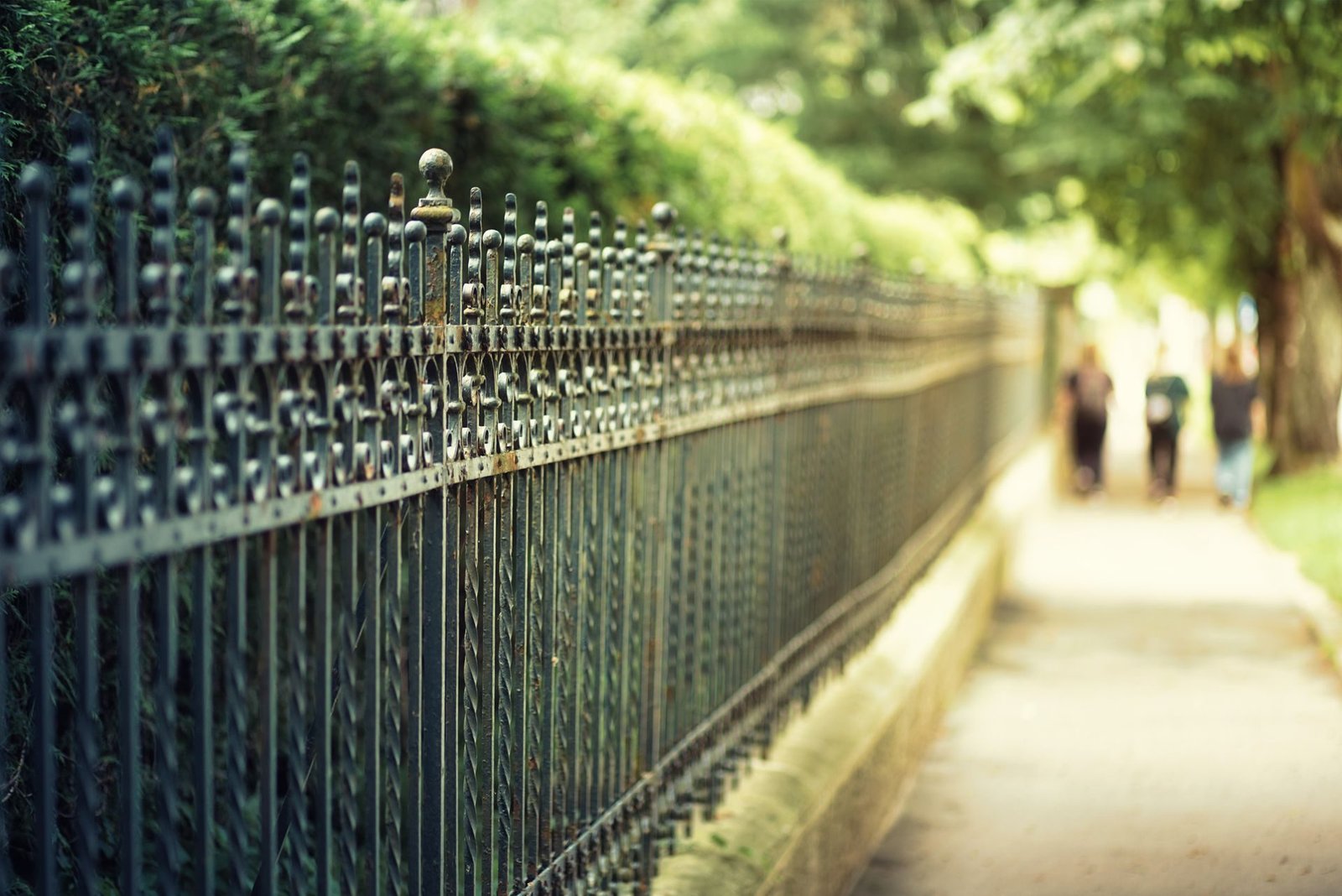 Black ornamental metal fence with decorative pickets
