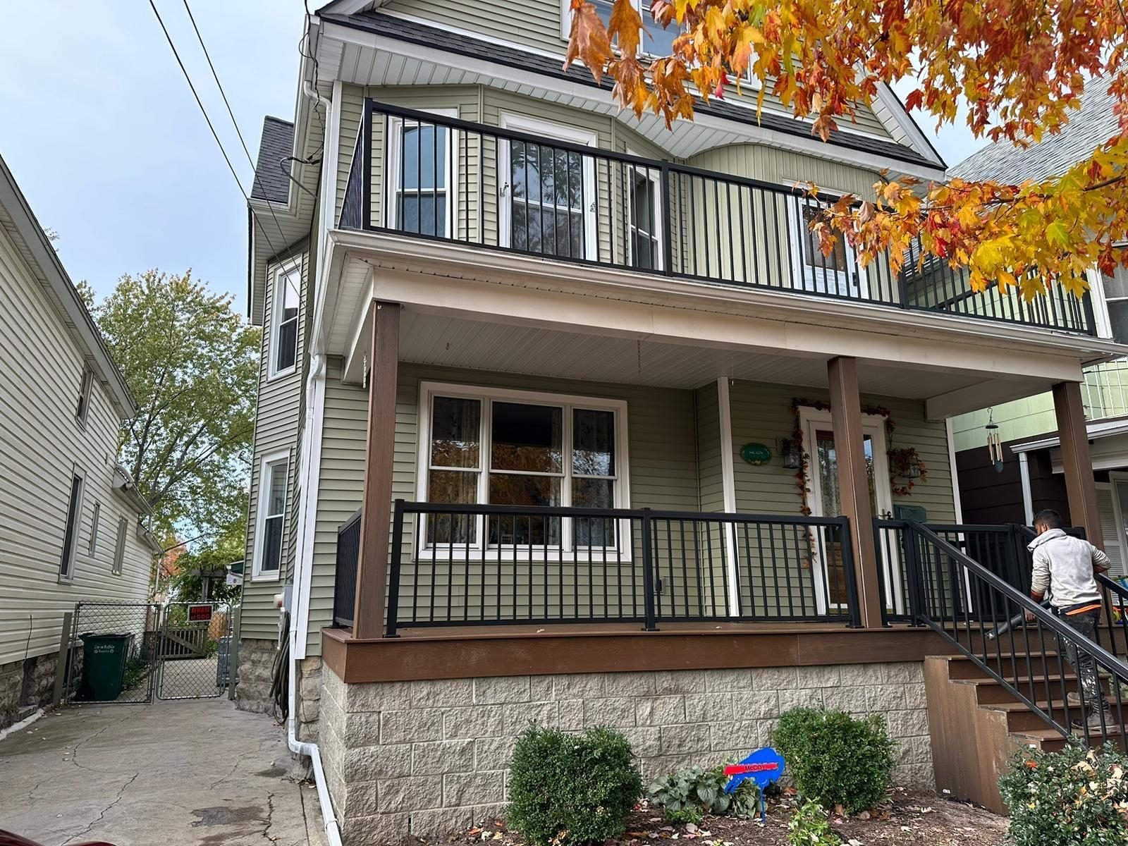 Two story Buffalo home with a covered wraparound front porch