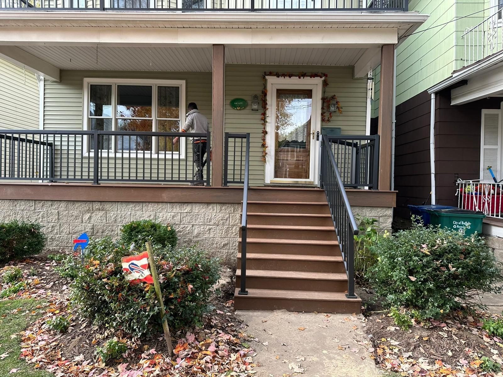 Finished covered porch with white railing and deck flooring