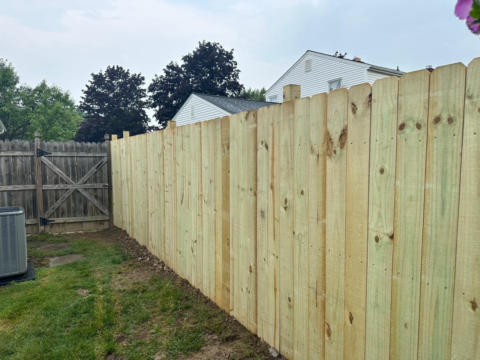 New wood privacy fence installation in a Buffalo NY backyard
