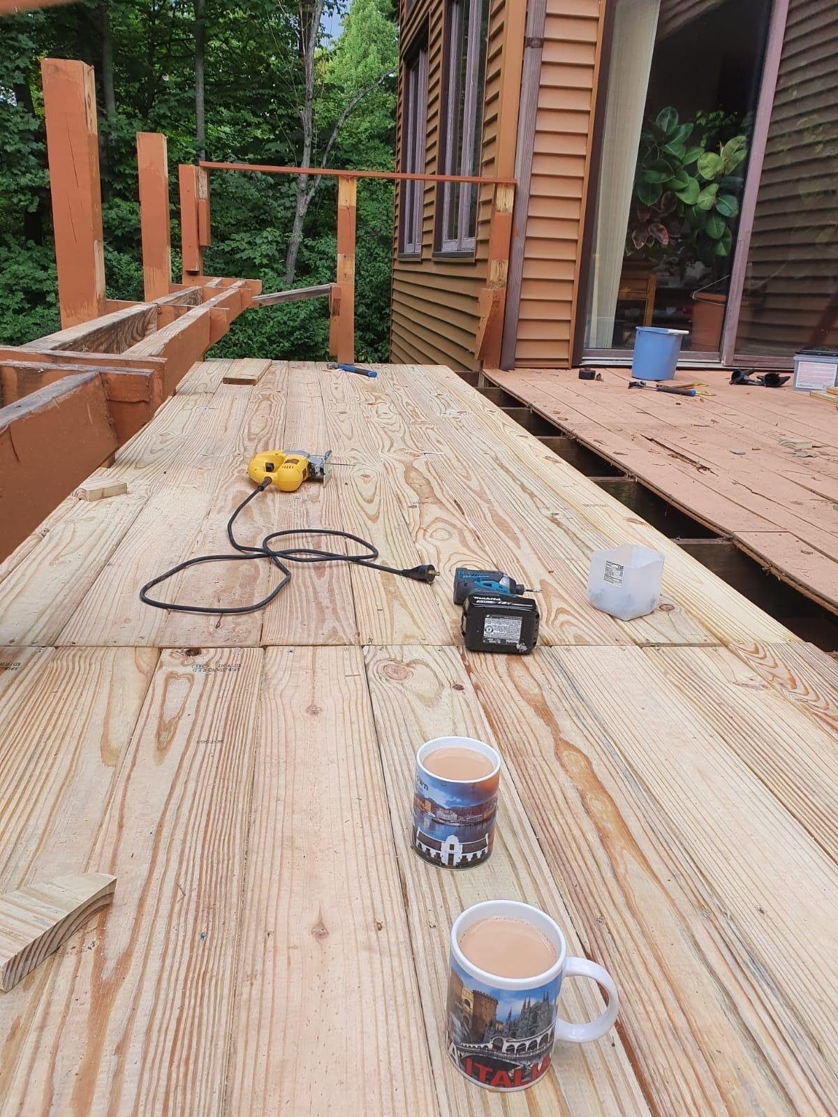 Deck construction jobsite with tools and crew