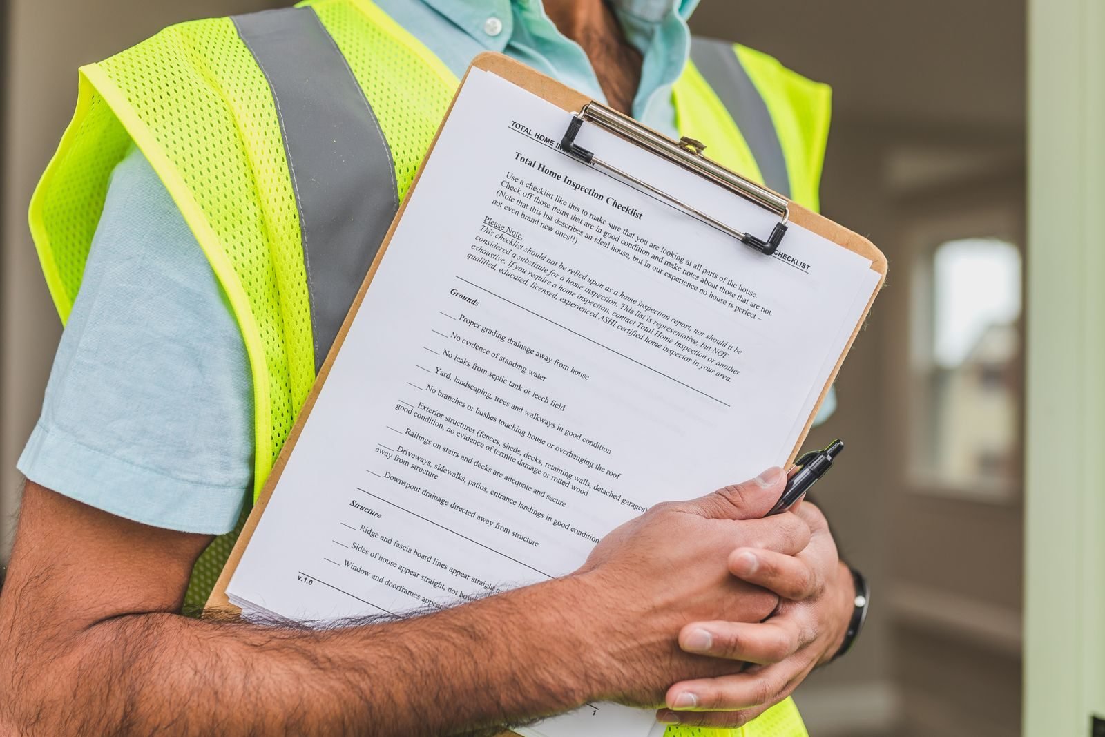 Inspector reviewing a home inspection checklist that includes deck condition