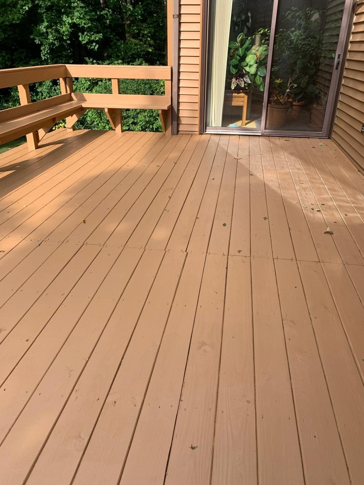 Finished deck staining project with warm brown tone