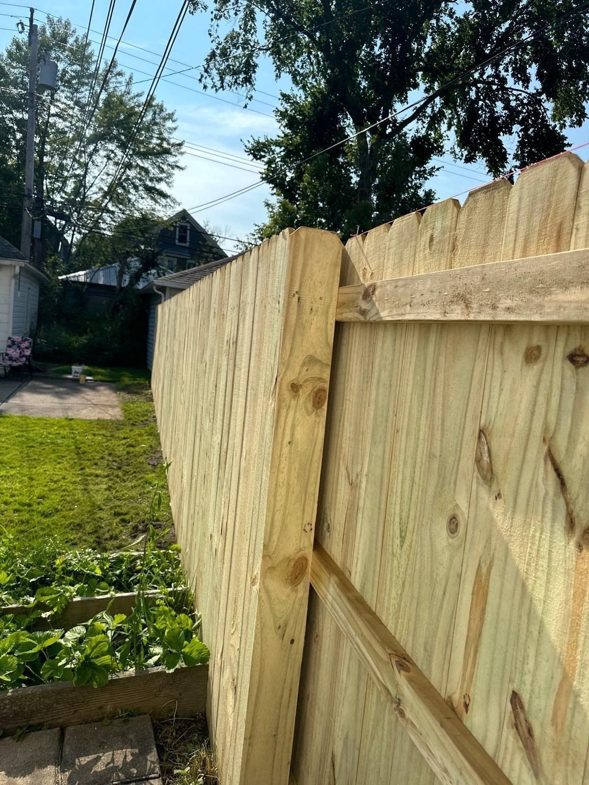 Fence panel being set into a post during installation