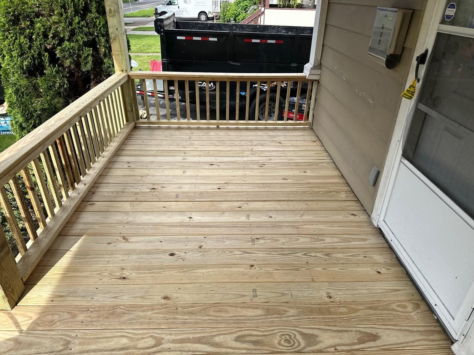 Wood porch flooring and railing installation