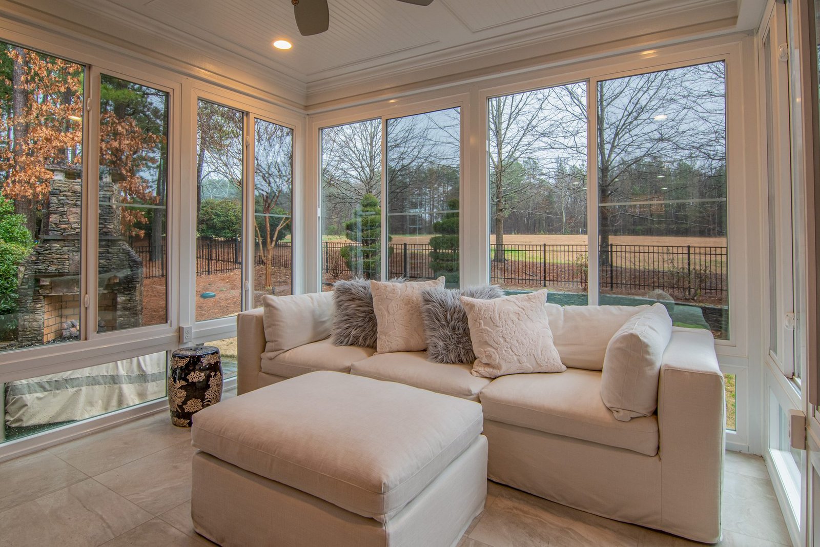 Glazed three season room with couch and large windows