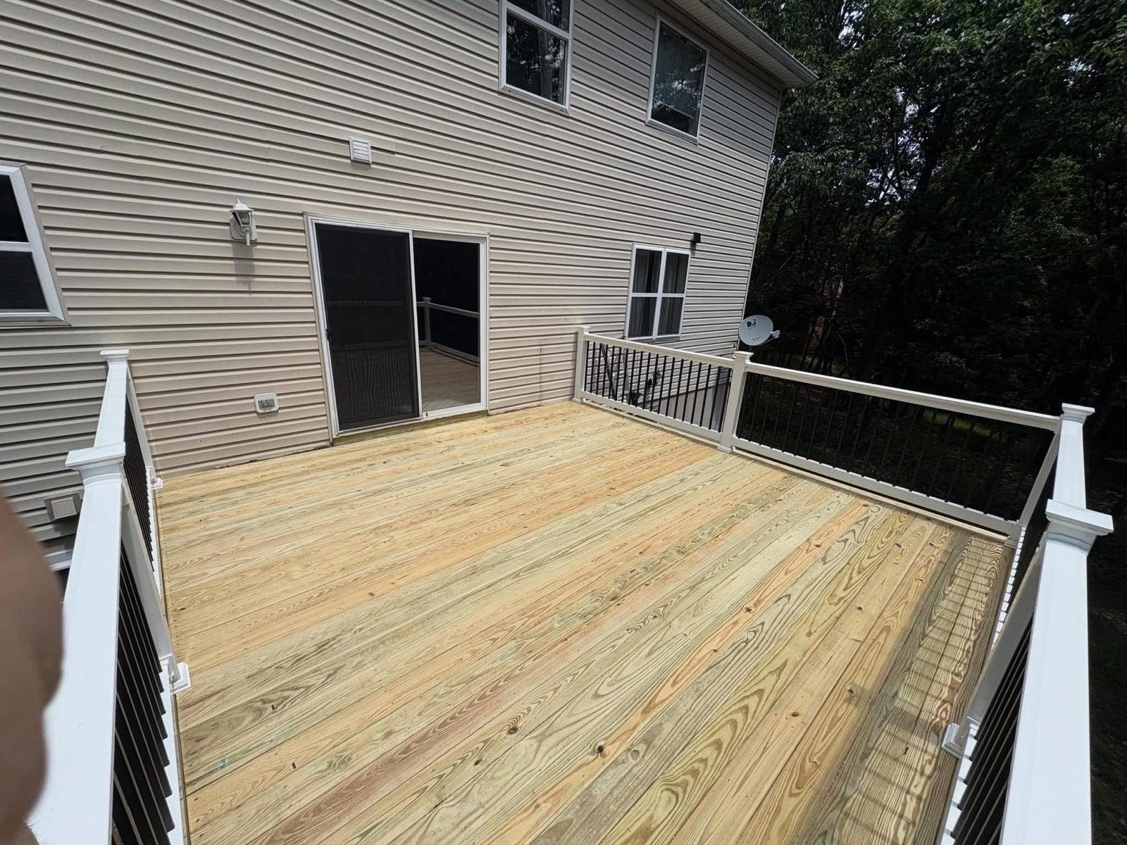 Wood deck installation overlooking a wooded backyard