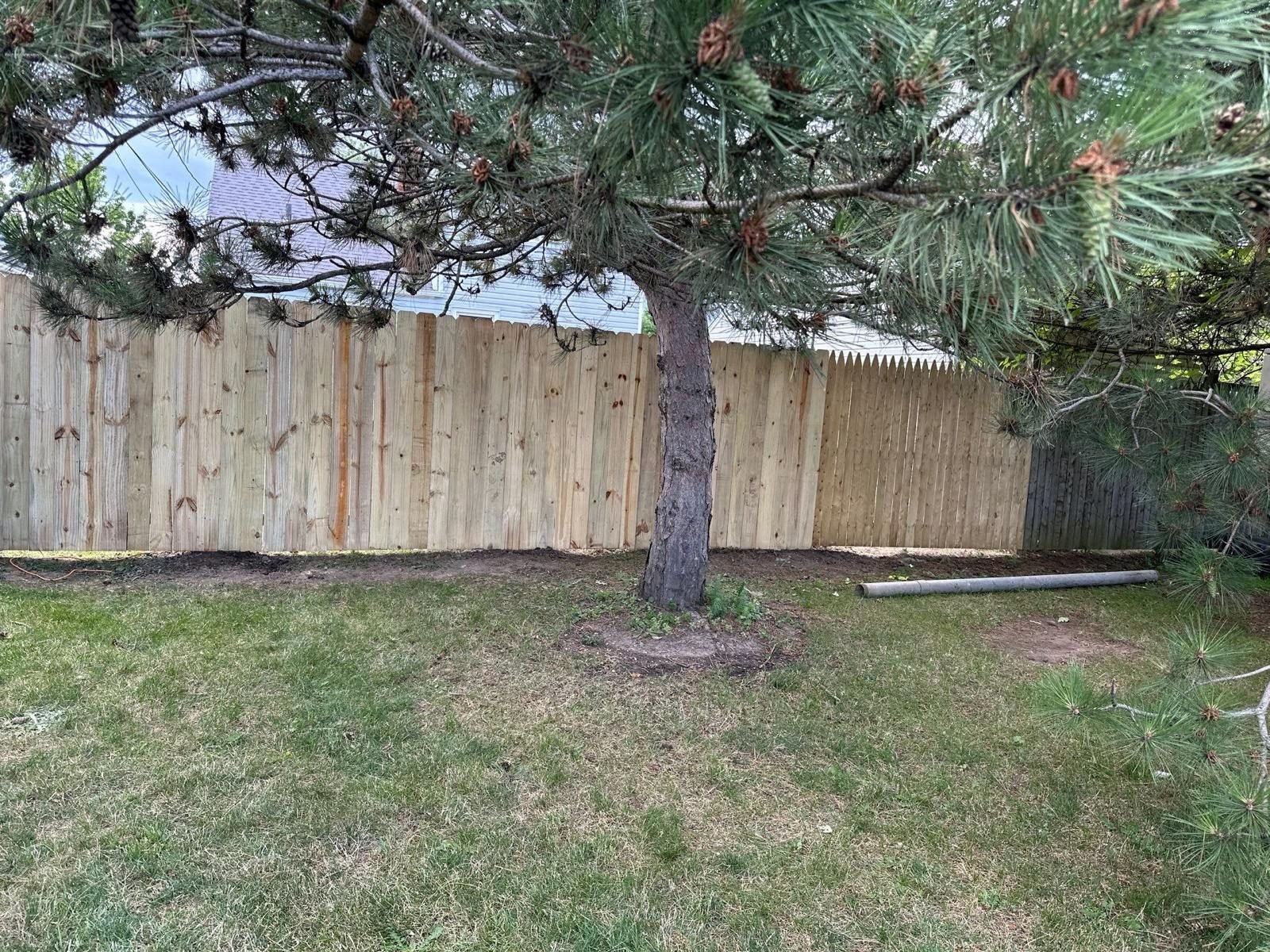 Wood fence panels installed along a property line
